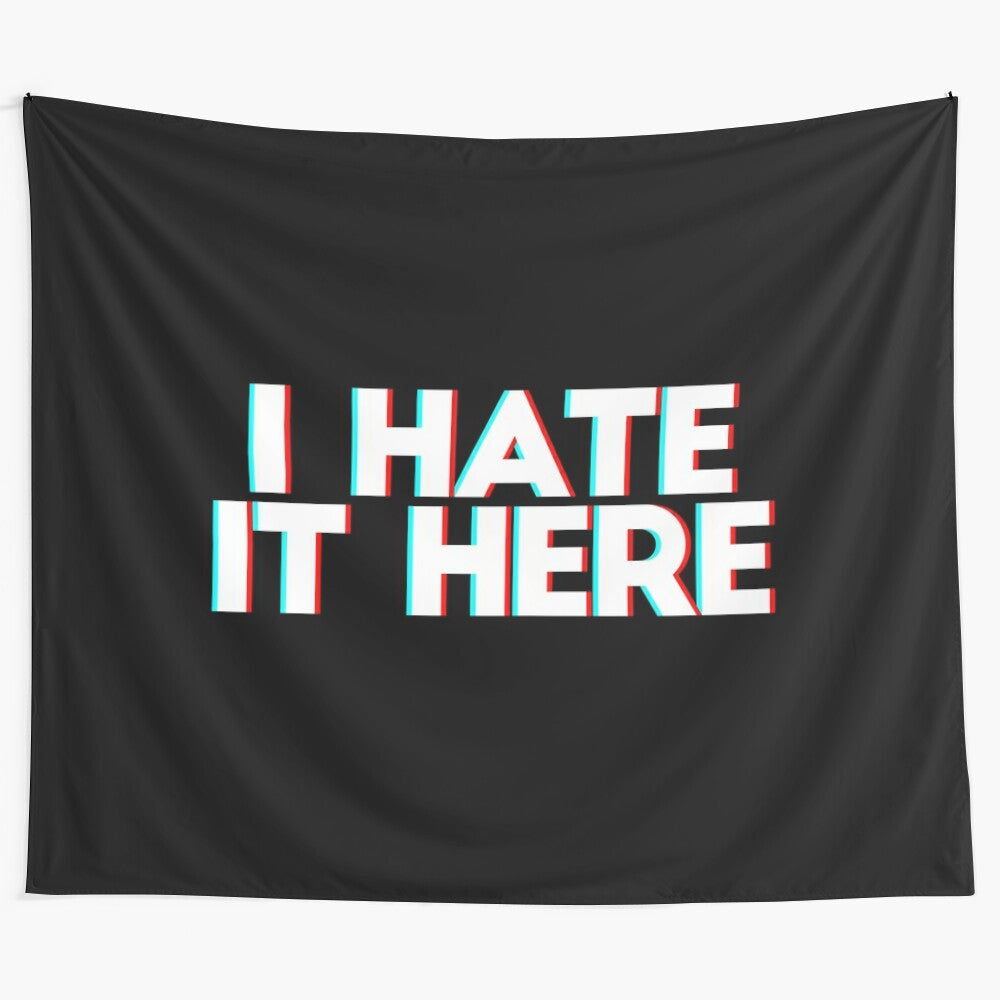 Tapestry with the phrase "I hate it here" in 3D anaglyph text, expressing mental health and emotional struggles.