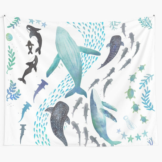 Watercolor painting of sharks, whales, turtles, and other marine life on a tapestry wall hanging