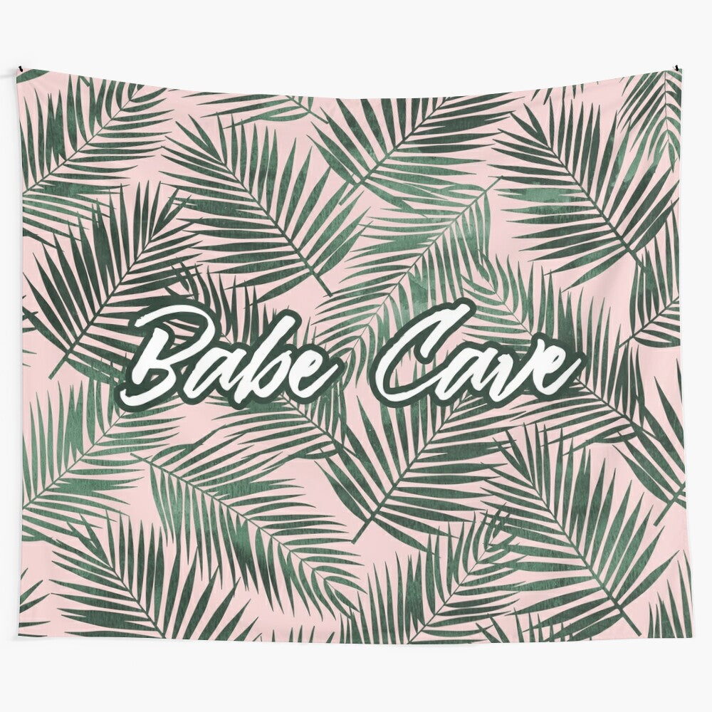 Babe Cave Tapestry featuring 3D pink and green design with palm leaves and handwritten lettering