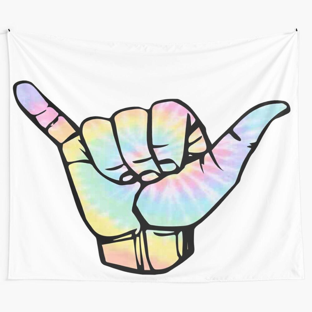 Colorful tie dye tapestry featuring the hang loose hand sign