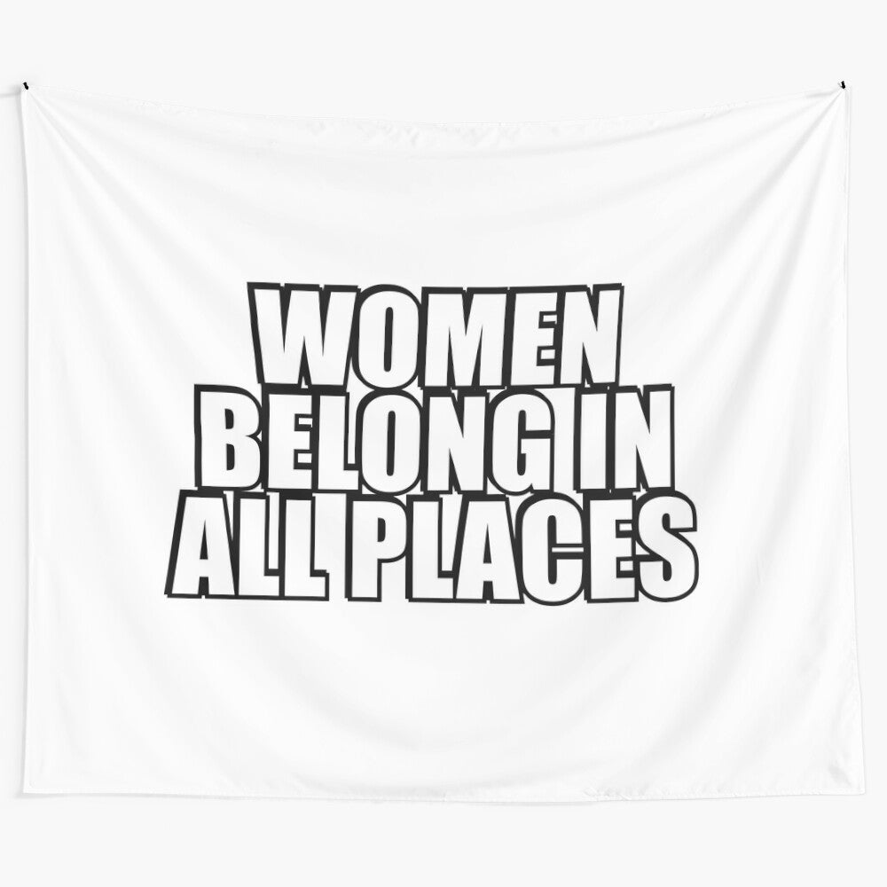 Artistic tapestry with the text "Women Belong in All Places" conveying a message of female empowerment and gender equality.