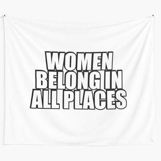 Artistic tapestry with the text "Women Belong in All Places" conveying a message of female empowerment and gender equality.