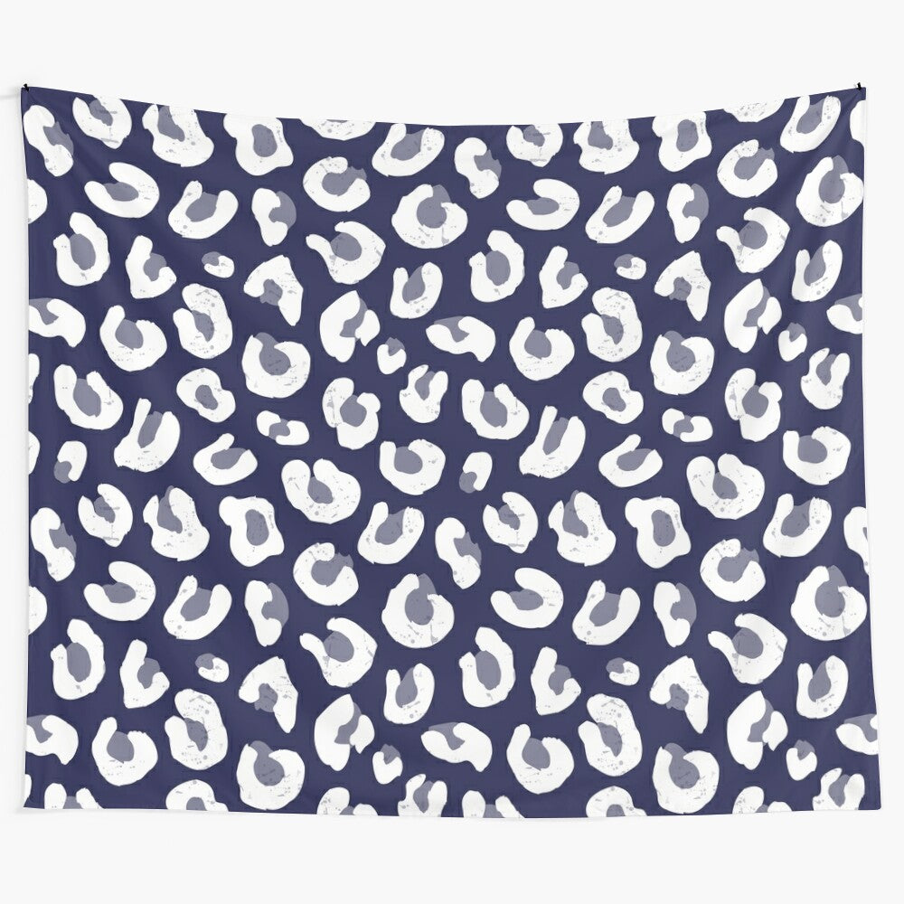 Leopard print tapestry in navy blue, white, and subtle tones