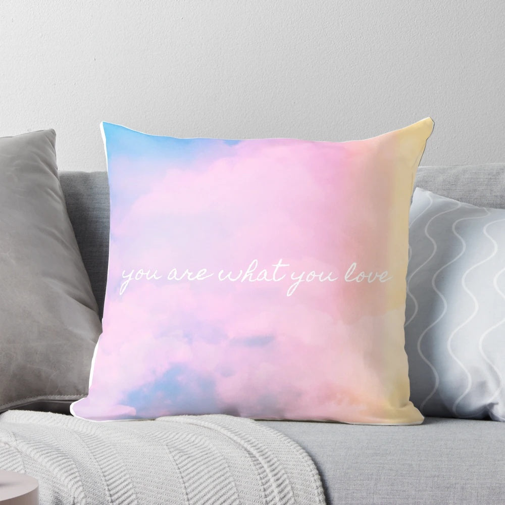 A soft, pink and pastel-colored throw pillow with a sunset and cloud design, inspired by Taylor Swift's aesthetic.