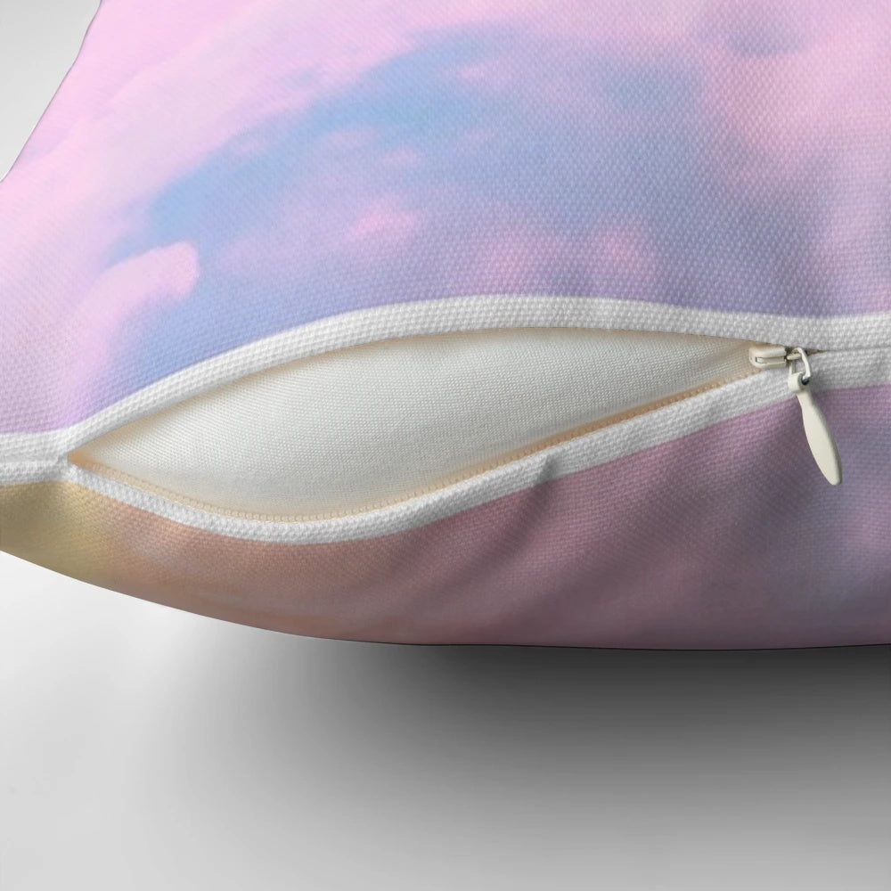 A soft, pink and pastel-colored throw pillow with a sunset and cloud design, inspired by Taylor Swift's aesthetic.