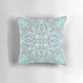 Teal and aqua lace mandala design on a grey decorative pillow