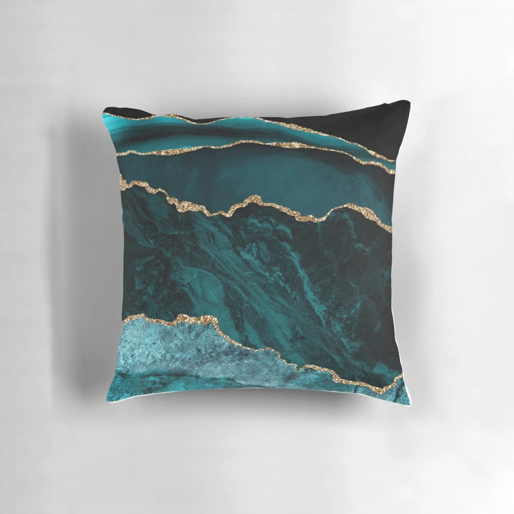 Teal and gold agate-inspired decorative pillow with a geode-like texture