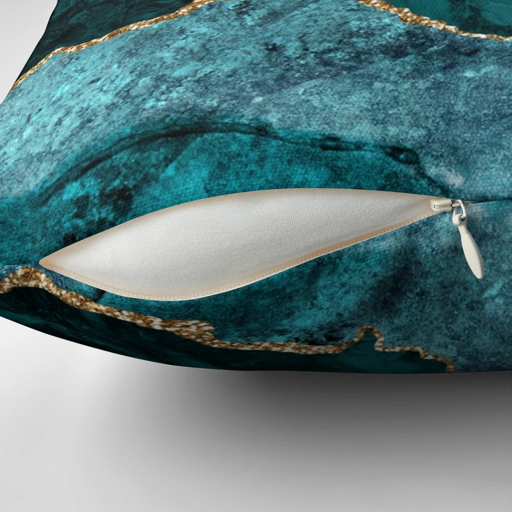 Teal and gold agate-inspired decorative pillow with a geode-like texture