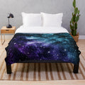 Teal and purple galaxy nebula plush blanket with stars and cosmic design