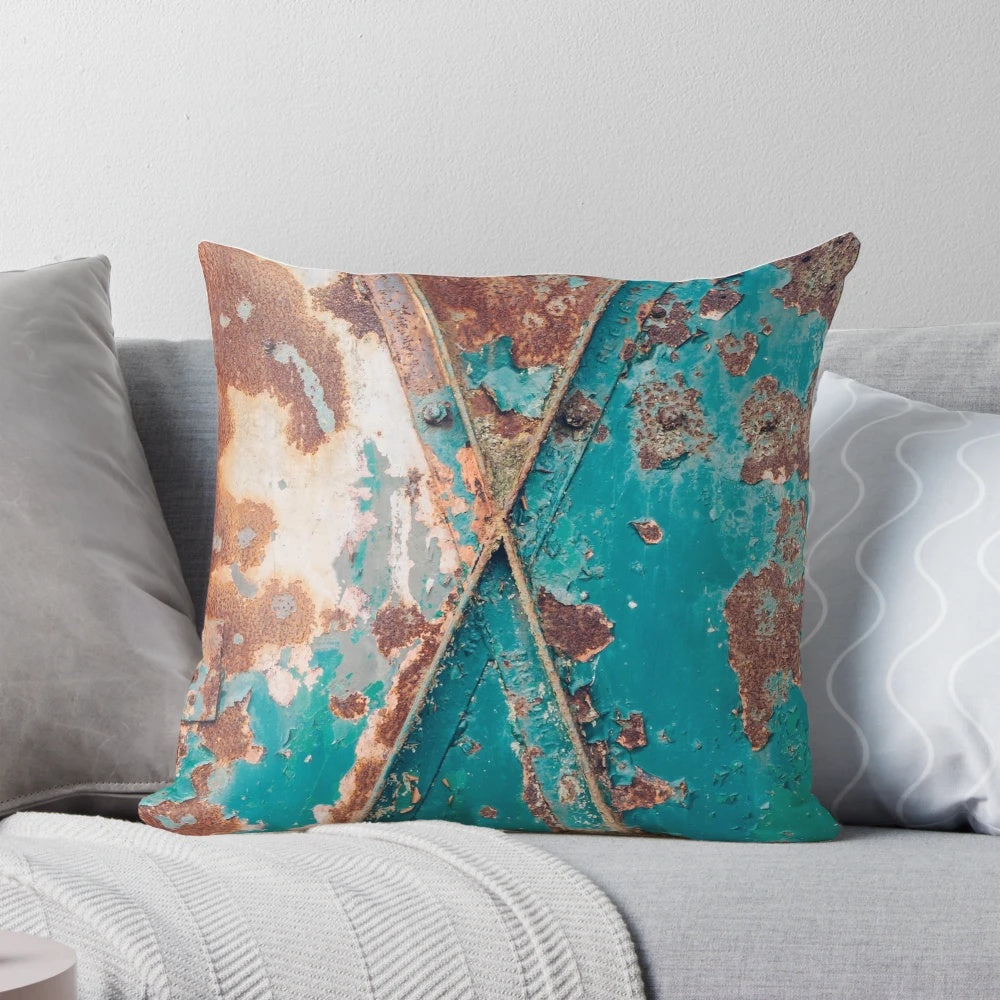 Teal and rust abstract pillow with a distressed, industrial-style design