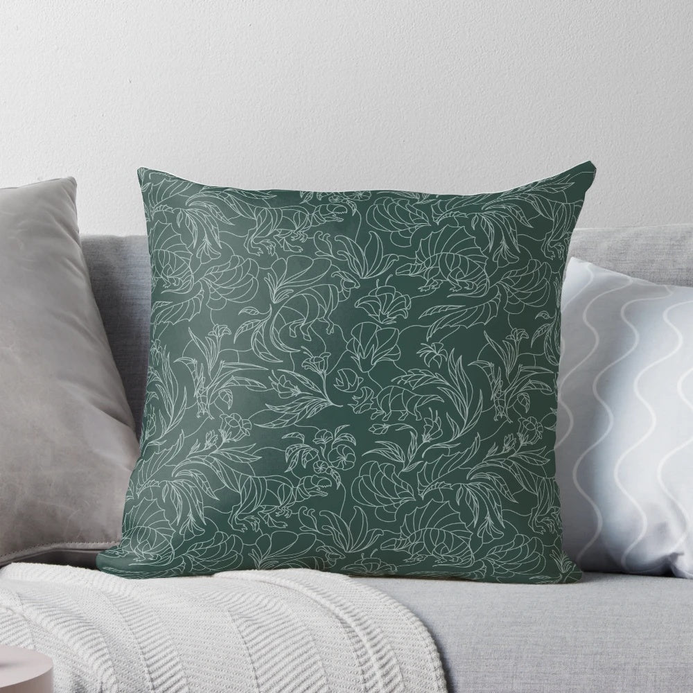 A decorative throw pillow featuring a floral pattern with hidden dinosaurs in teal and silver colors.