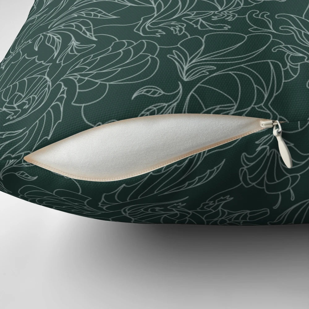 A decorative throw pillow featuring a floral pattern with hidden dinosaurs in teal and silver colors.