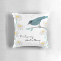 Teal and blue pillow with a collage design featuring three little birds and daisies