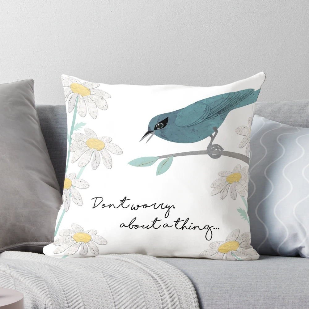 Teal and blue pillow with a collage design featuring three little birds and daisies