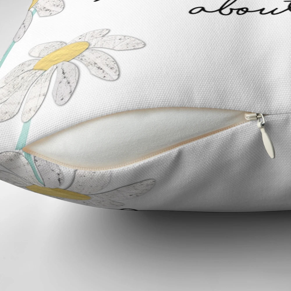 Teal and blue pillow with a collage design featuring three little birds and daisies