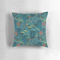 A beautiful teal, gold, and black throw pillow featuring a Japanese garden scene with flowers, birds, and silhouettes.