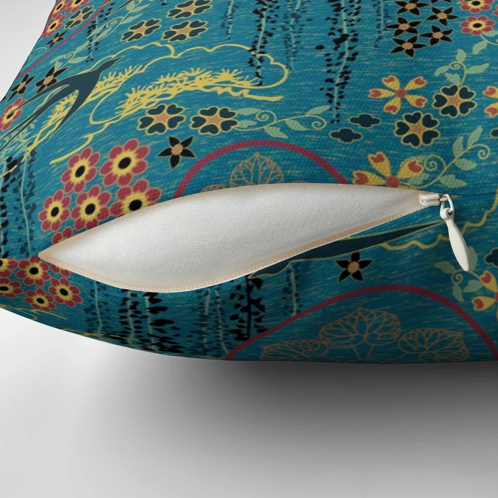 A beautiful teal, gold, and black throw pillow featuring a Japanese garden scene with flowers, birds, and silhouettes.