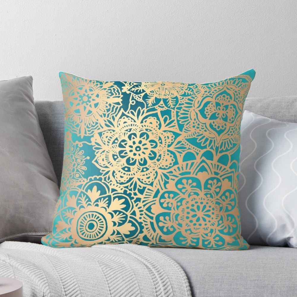Teal green and gold mandala pattern decorative pillow with a bohemian, modern design.