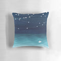 Teal and white pillow with a garland of stars design, depicting a paper boat sailing on the ocean.