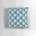 Teal pillow with a winter scene featuring Yukon Cornelius and the Abominable Snowman