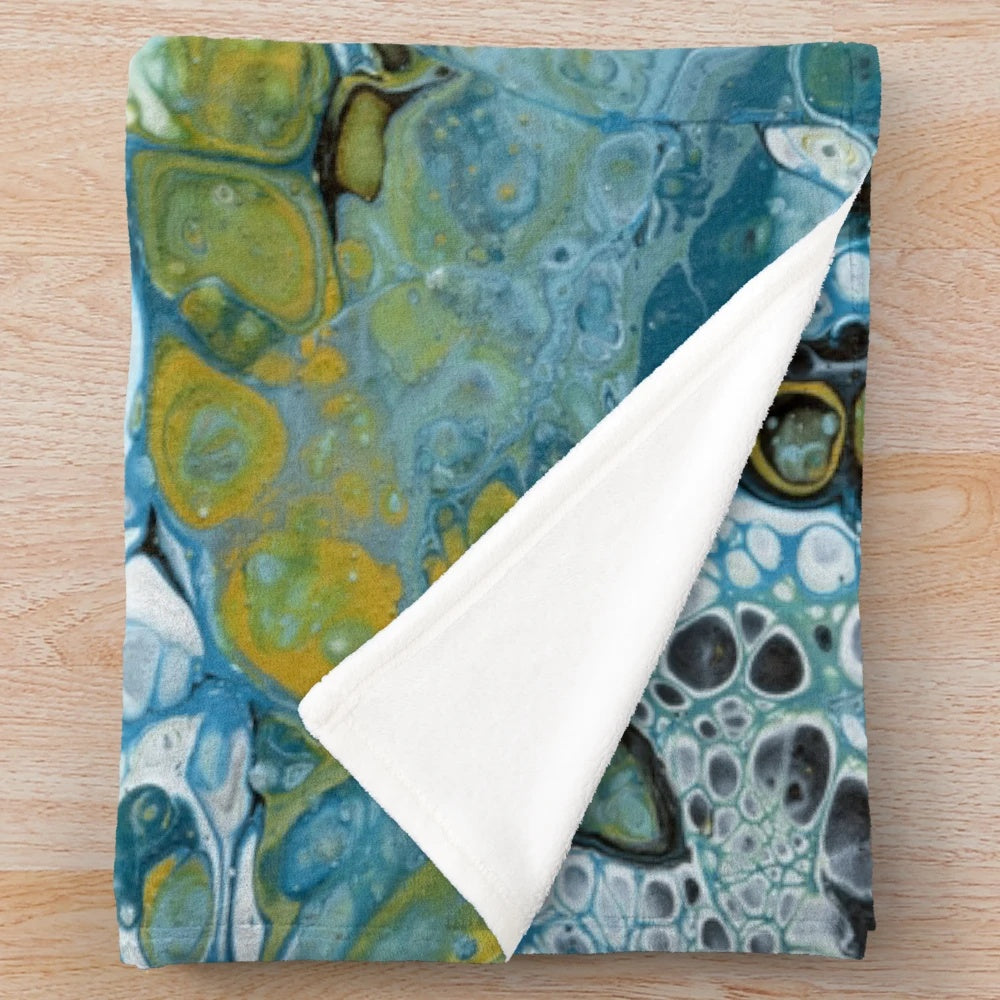 Teal plush blanket with abstract wave pattern