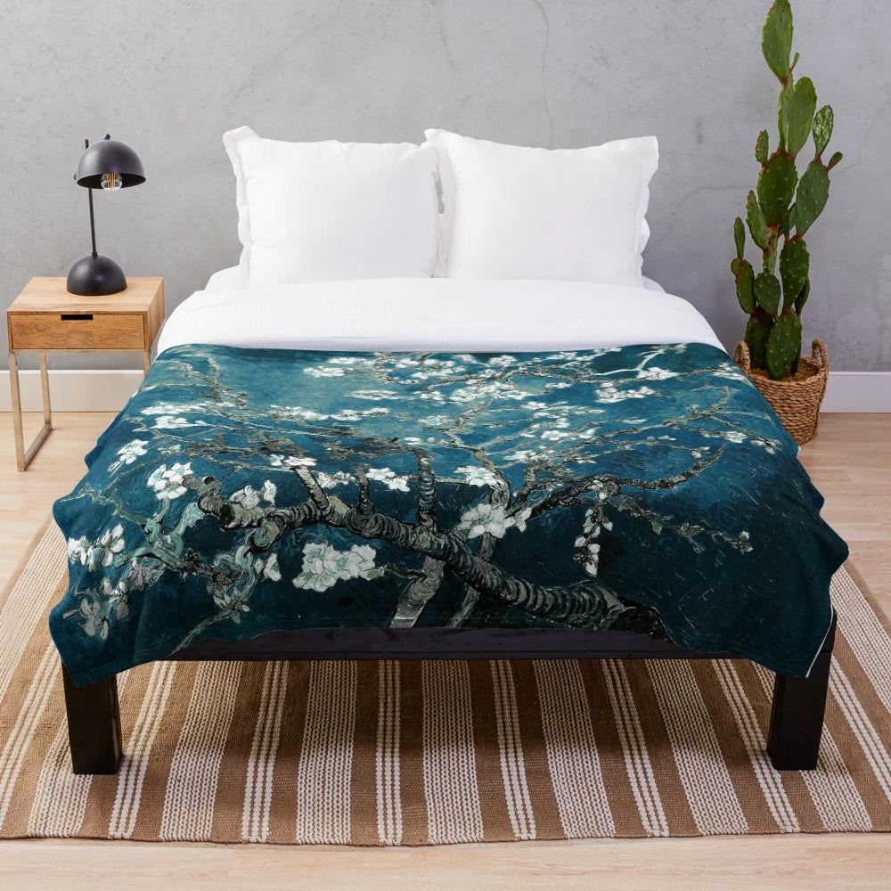 Teal plush blanket featuring an impressionist-style floral design inspired by Van Gogh's Almond Blossoms painting