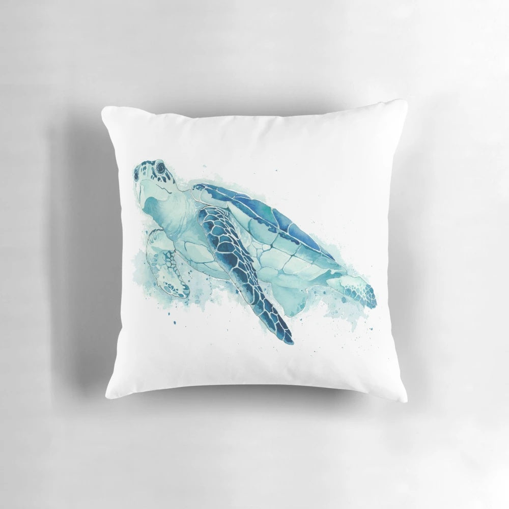 Vibrant watercolor painting of a sea turtle printed on a teal blue throw pillow for coastal home decor.