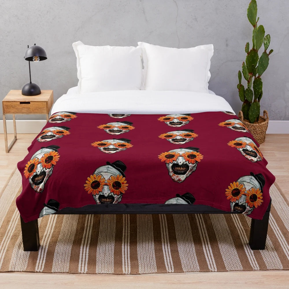 Terrifying Art the Clown from Terrifier 2 on a plush sunflower sunglasses blanket