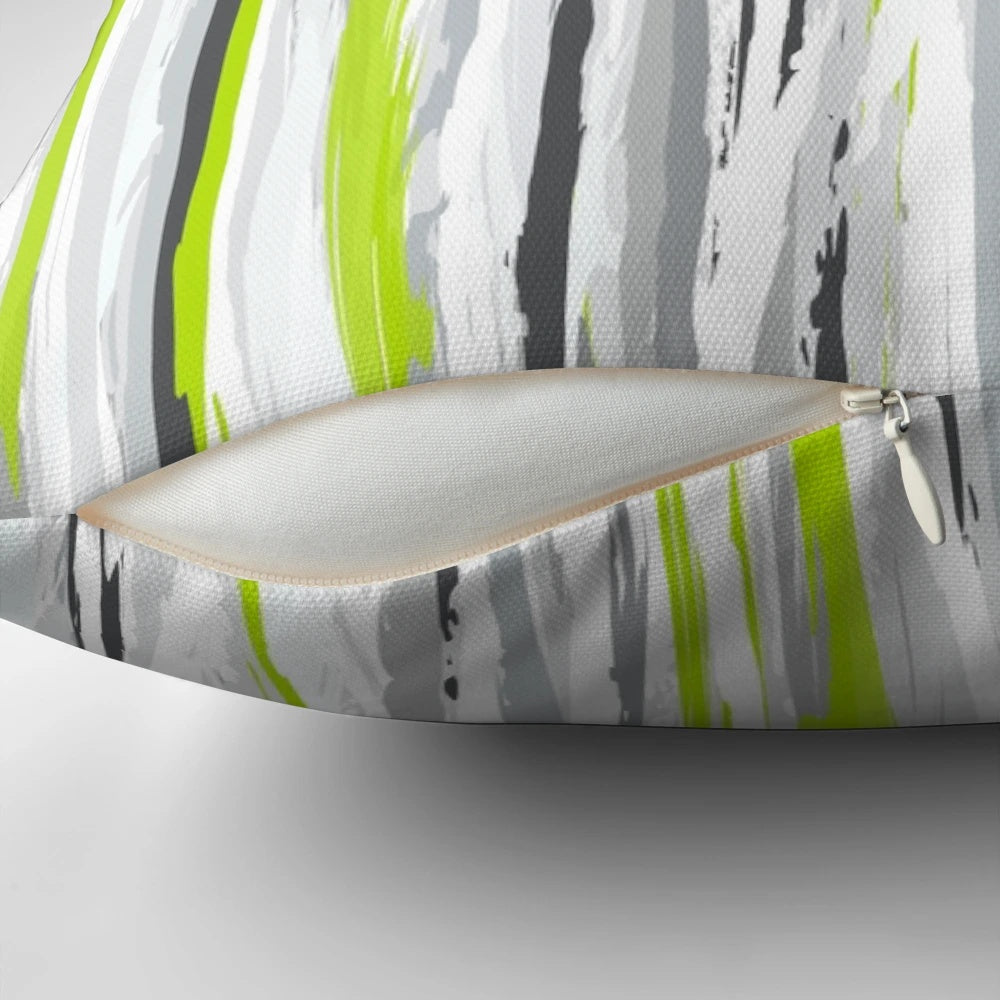 A stylish and textural striped pillow in shades of lime, grey, black, and white for a modern home decor accent.