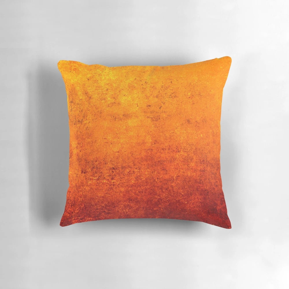 A textured abstract industrial art pillow with dark red and orange colors