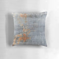 Pillow with an aged, grungy metal texture in shades of blue and rust.