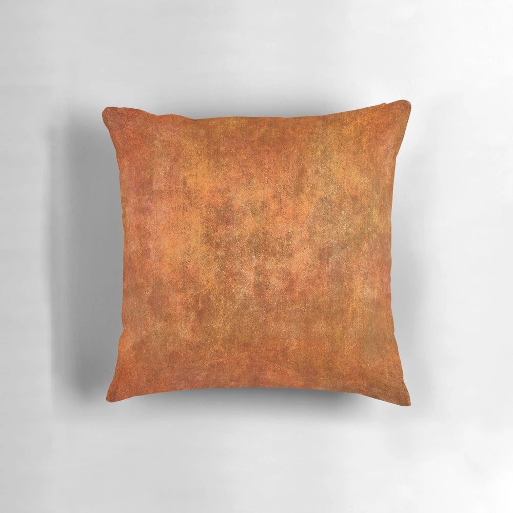 Textured rust and stone pillow with a rugged surface texture