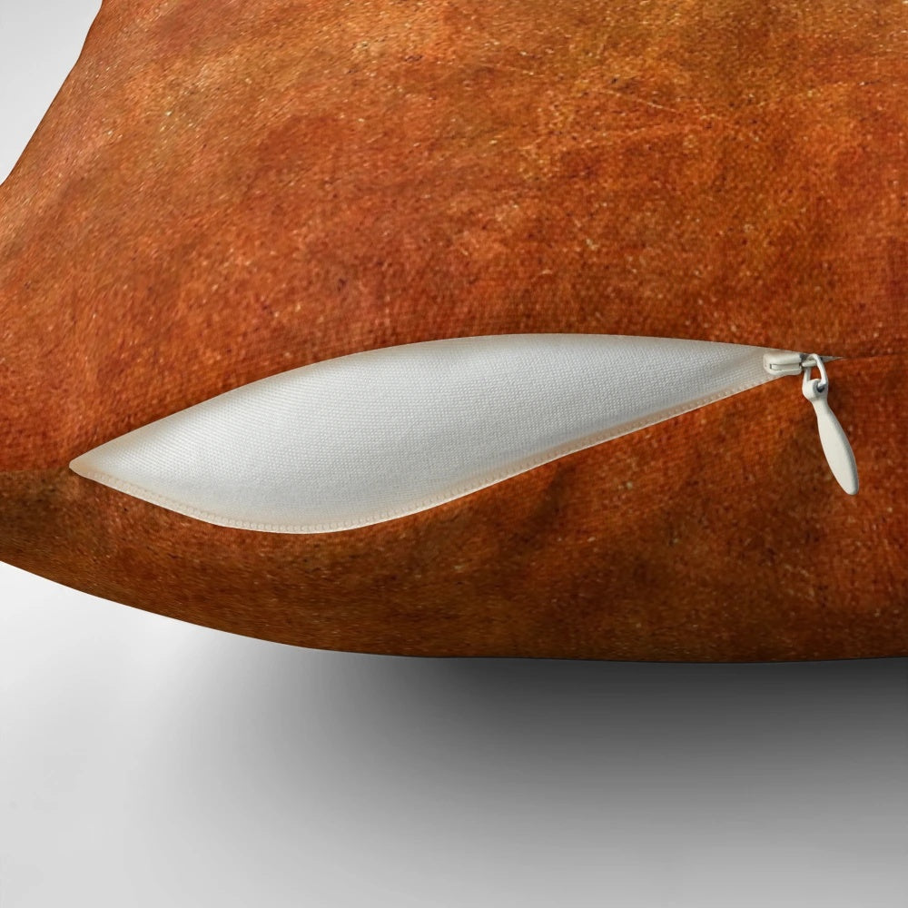 Textured rust and stone pillow with a rugged surface texture