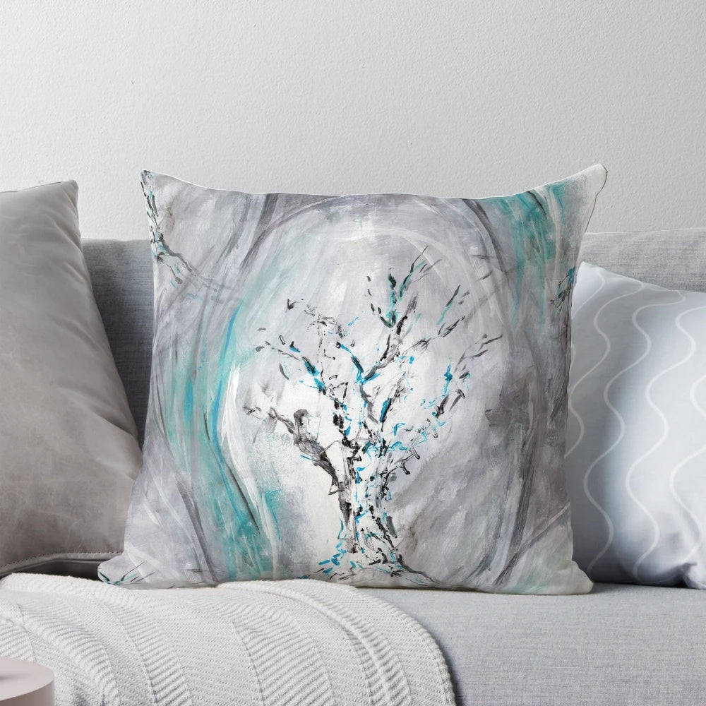 Decorative teal and gray throw pillow featuring an abstract painting of flowing tree branches