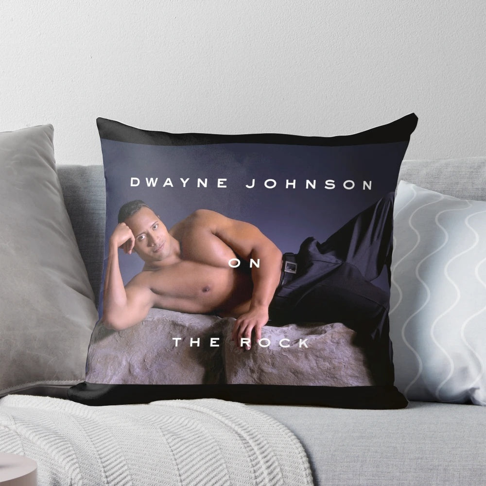 A plush pillow featuring a stylized image of Dwayne "The Rock" Johnson, the popular movie star and champion.