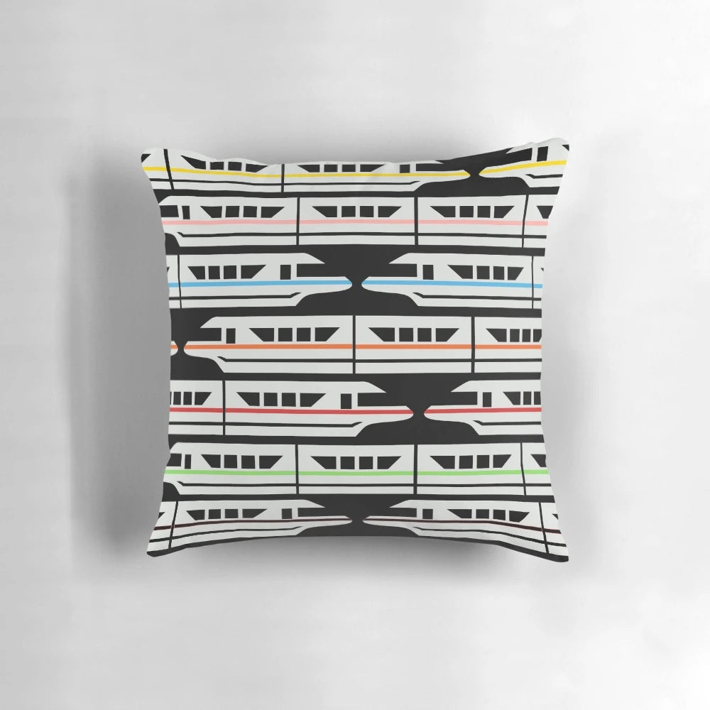 Colorful Disney-inspired pillow featuring a classic monorail design in red, yellow, blue, and green.