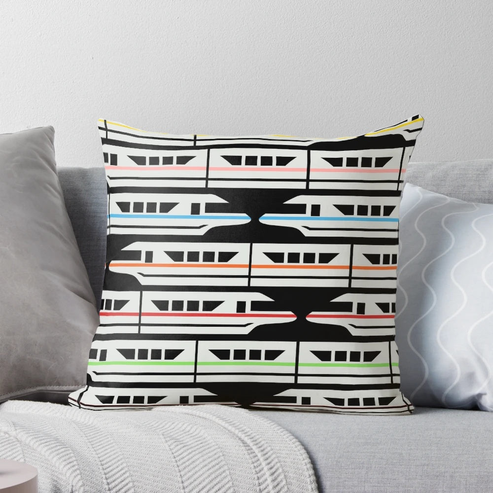 Colorful Disney-inspired pillow featuring a classic monorail design in red, yellow, blue, and green.