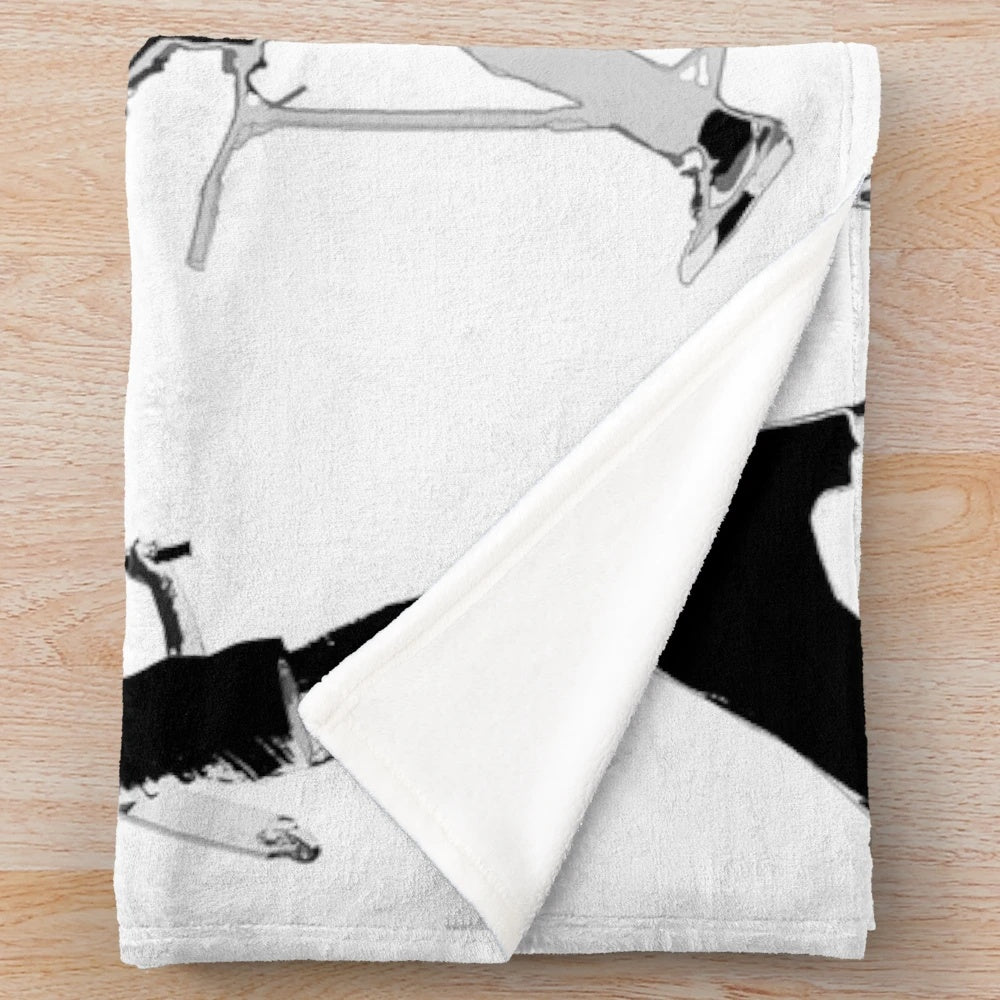 Plush blanket featuring a scooter performing stunts and tricks