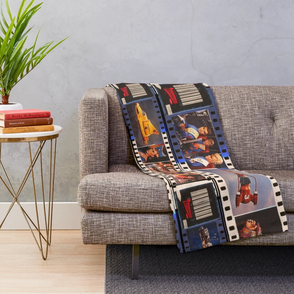 Thunderbirds-inspired plush blanket featuring the Tracy family and sci-fi elements