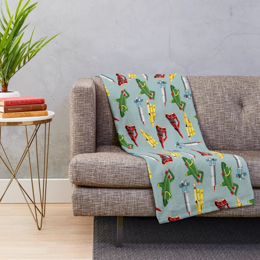 Thunderbirds-inspired plush blanket with a retro sci-fi spaceship pattern