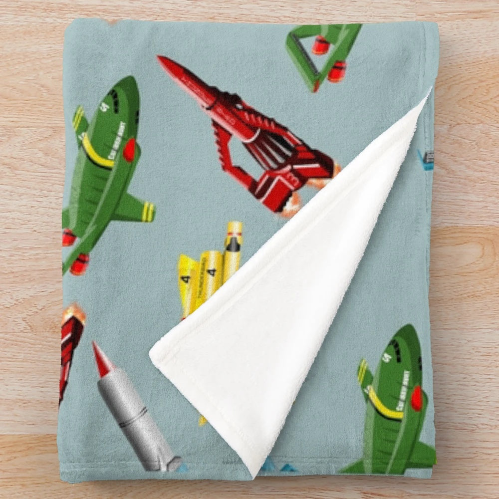 Thunderbirds-inspired plush blanket with a retro sci-fi spaceship pattern