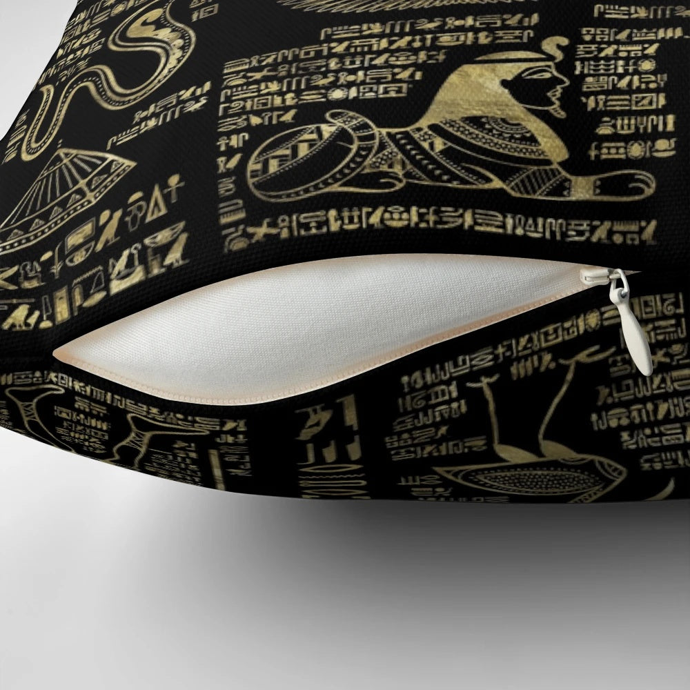 Ornate Egyptian hieroglyphs and deities depicted in shimmering gold on a black pillow