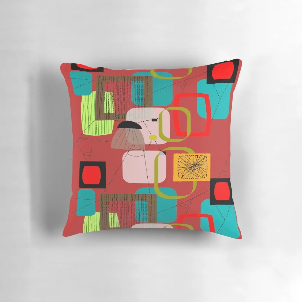 A vibrant mid-century modern abstract art pillow featuring bold colors and geometric patterns.