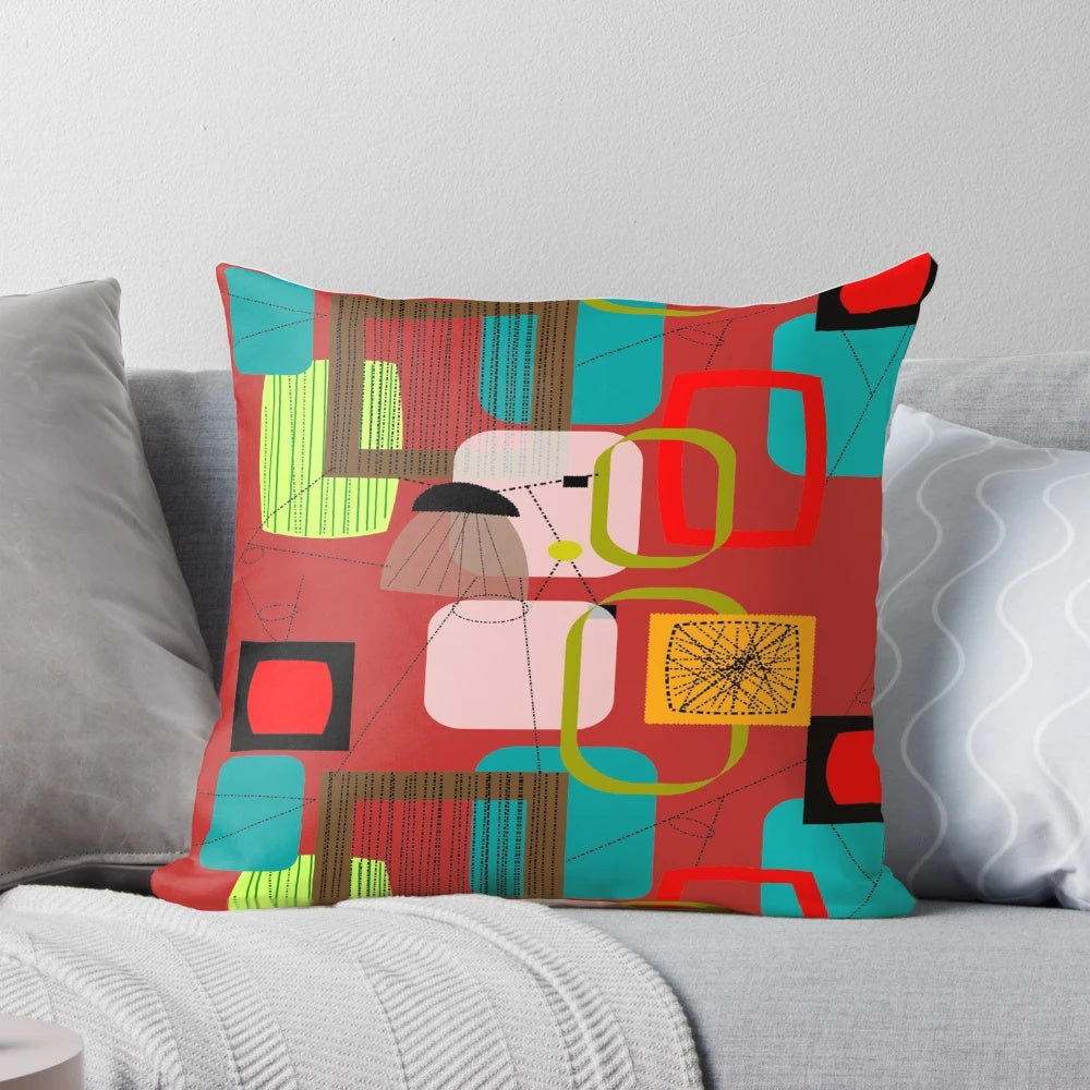 A vibrant mid-century modern abstract art pillow featuring bold colors and geometric patterns.