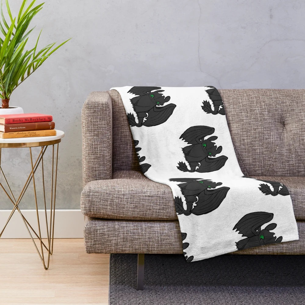 Toothless inspired plush blanket featuring the iconic Night Fury dragon from the How to Train Your Dragon movie franchise.
