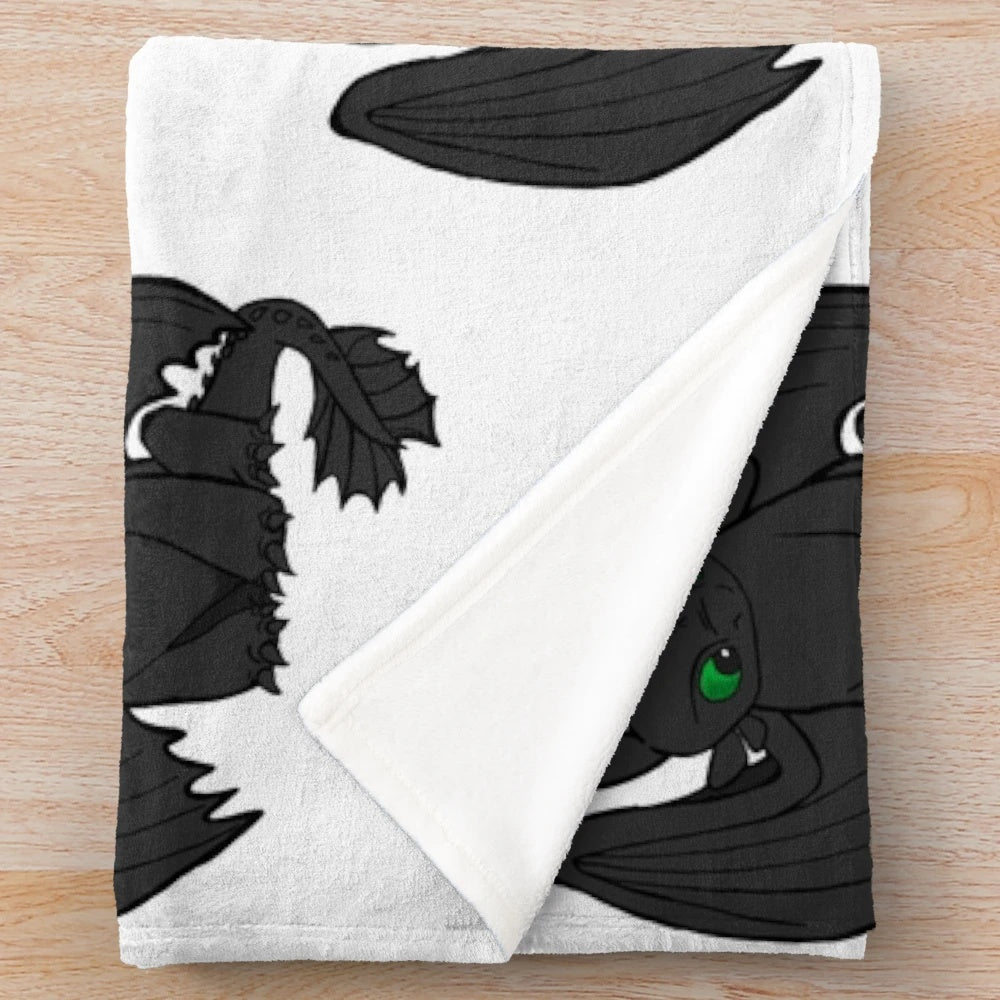 Toothless inspired plush blanket featuring the iconic Night Fury dragon from the How to Train Your Dragon movie franchise.