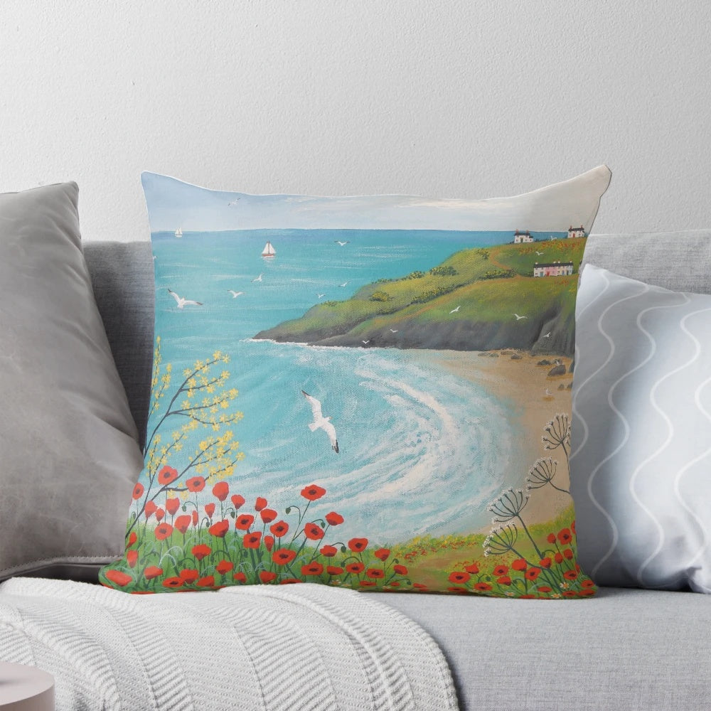 A decorative pillow featuring a serene coastal landscape with vibrant poppies.