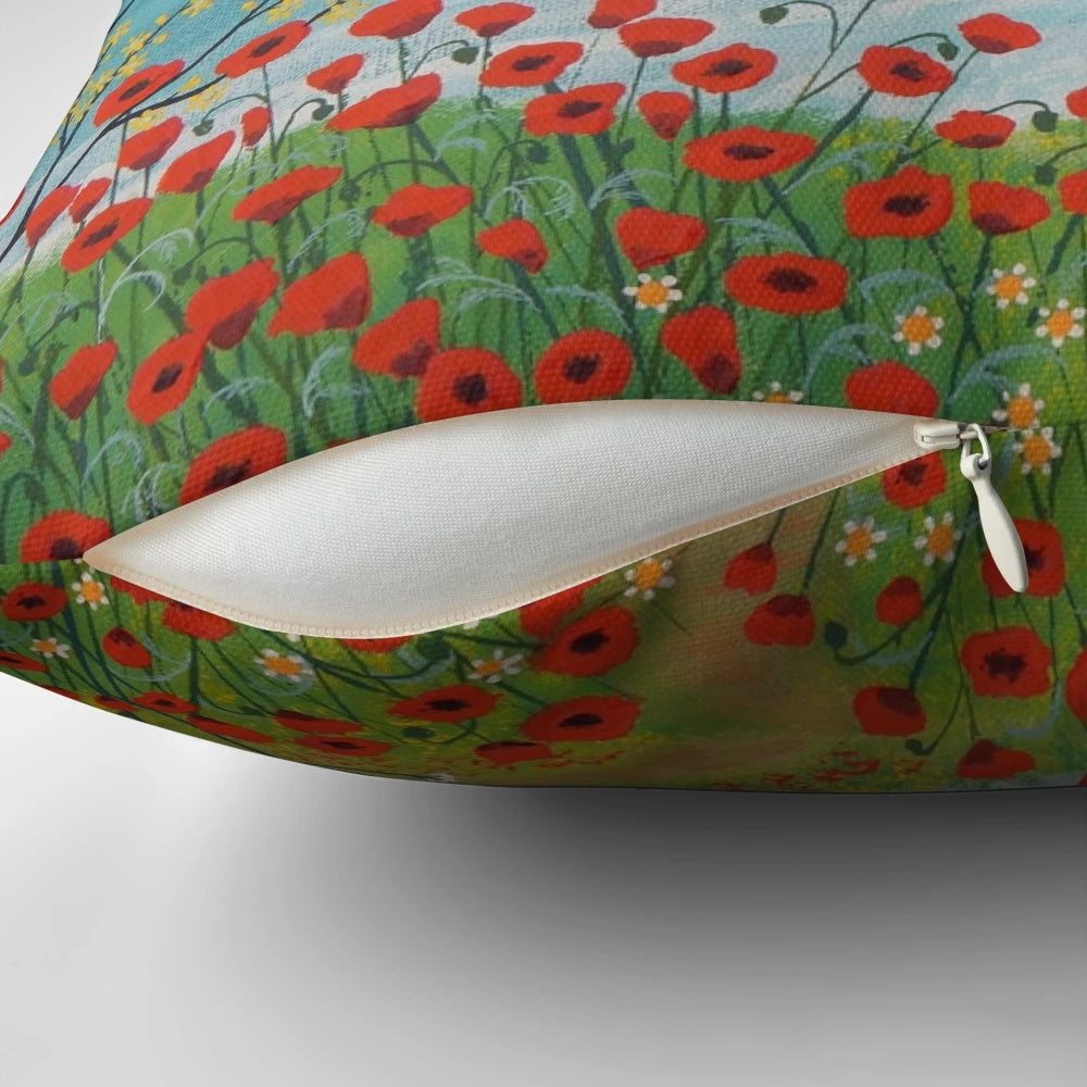 A decorative pillow featuring a serene coastal landscape with vibrant poppies.