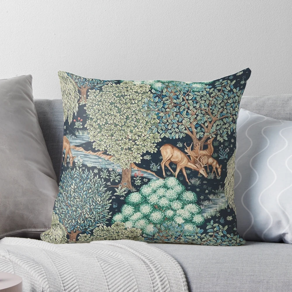 A beautiful floral pillow featuring a serene scene of deer by a brook in a verdant forest setting.