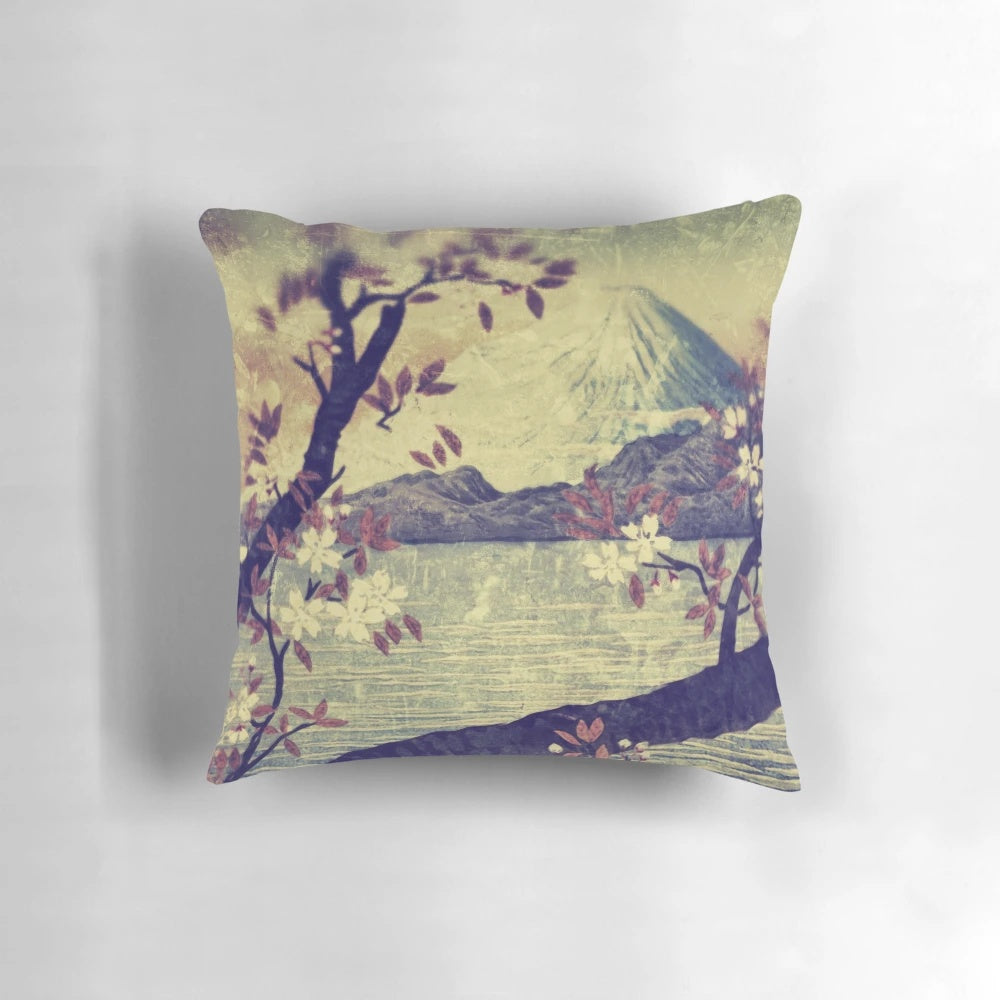 A decorative pillow featuring a serene Japanese landscape with Mount Fuji, a mountain lake, and delicate flowers.